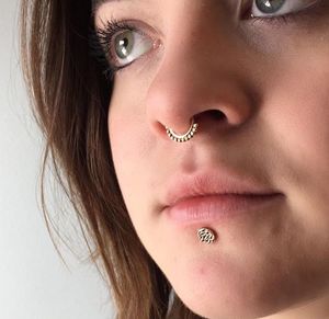 Septum piercing with a rose gold latchmi